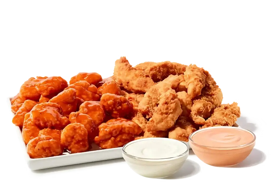 Platter with chicken fingers, boneless wings, fries, and coleslaw with dipping sauces