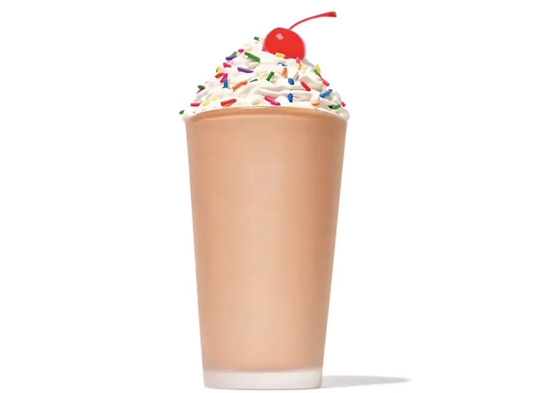 Thick and creamy chocolate milkshake topped with whipped cream in a tall glass
