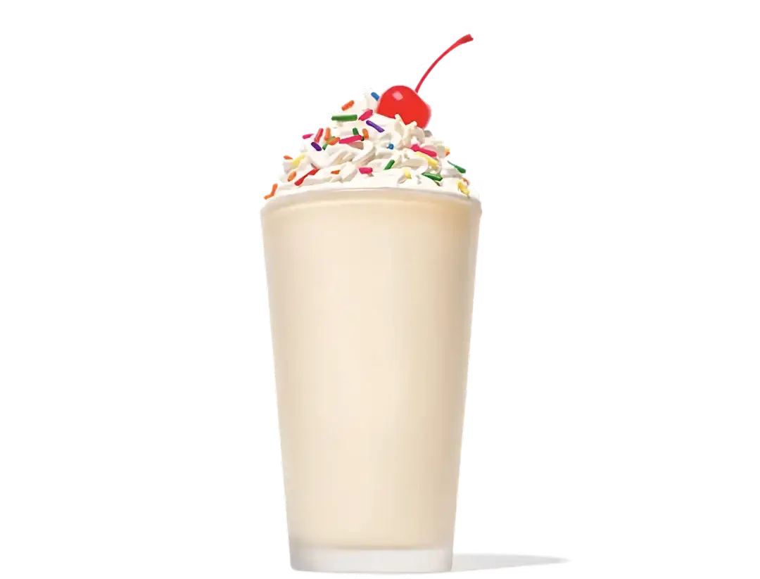 Thick and creamy chocolate milkshake topped with whipped cream in a tall glass