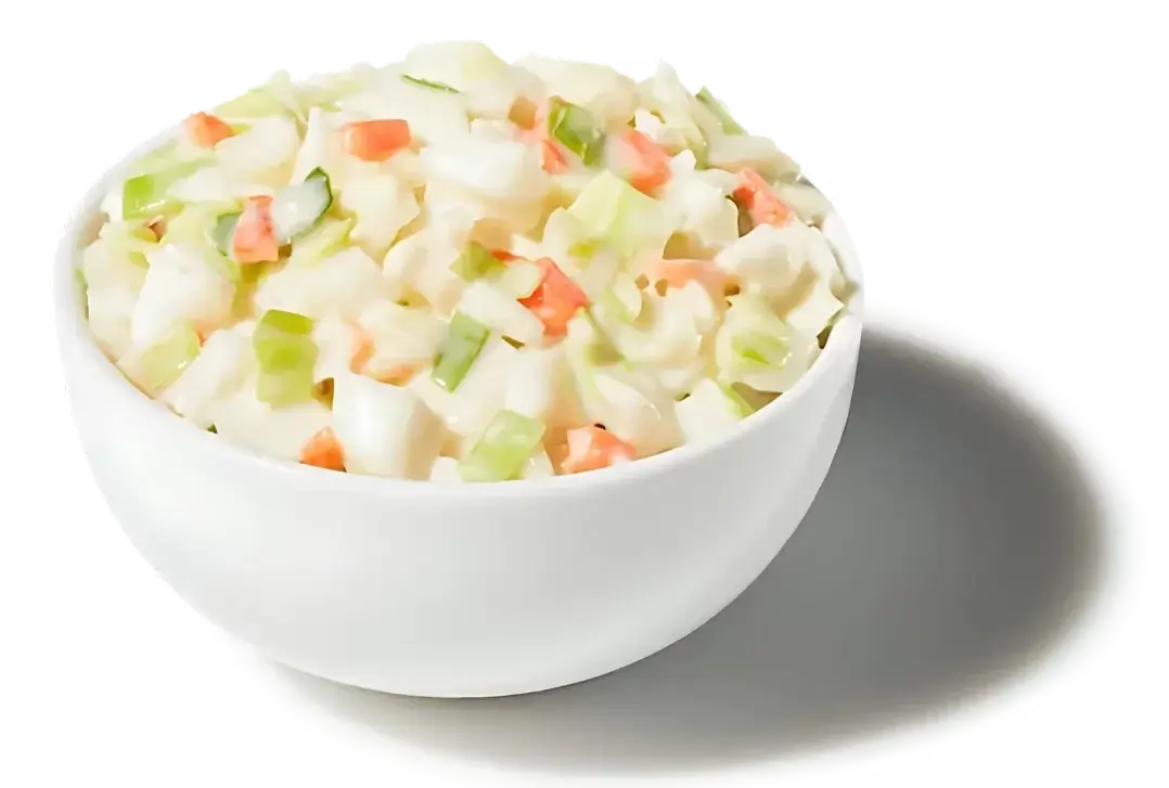"Cup of creamy coleslaw with shredded cabbage and carrots"