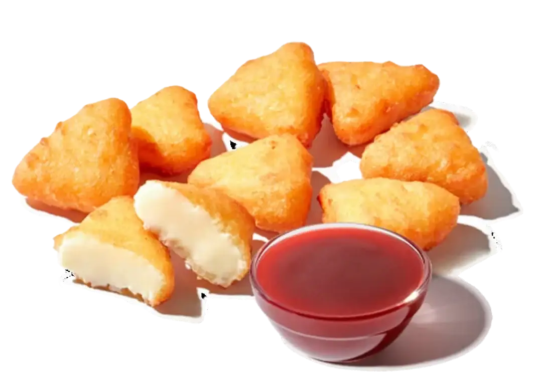 Golden-fried cheesecake bites with crispy coating served alongside rich strawberry dipping sauce on a plate