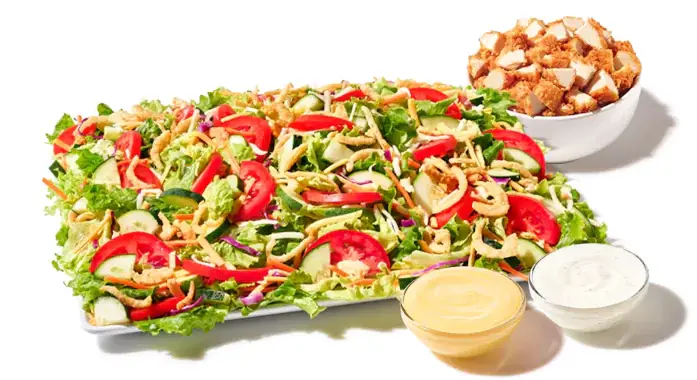 Salad platter with crispy chicken, mixed greens, tomatoes, cheese, croutons, Texas toast, and dressing
