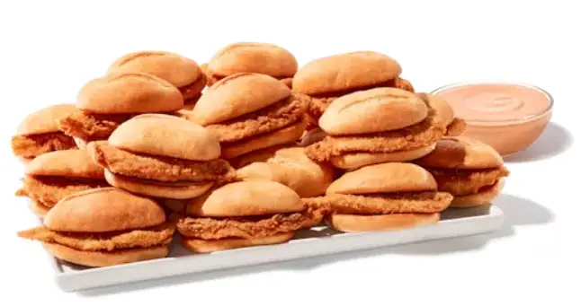 Platter with crispy chicken nibblers, fries, coleslaw, Texas toast, and dipping sauces