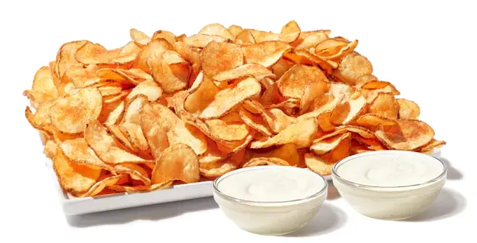 Platter with crispy tater chips, coleslaw, Texas toast, and dipping sauces